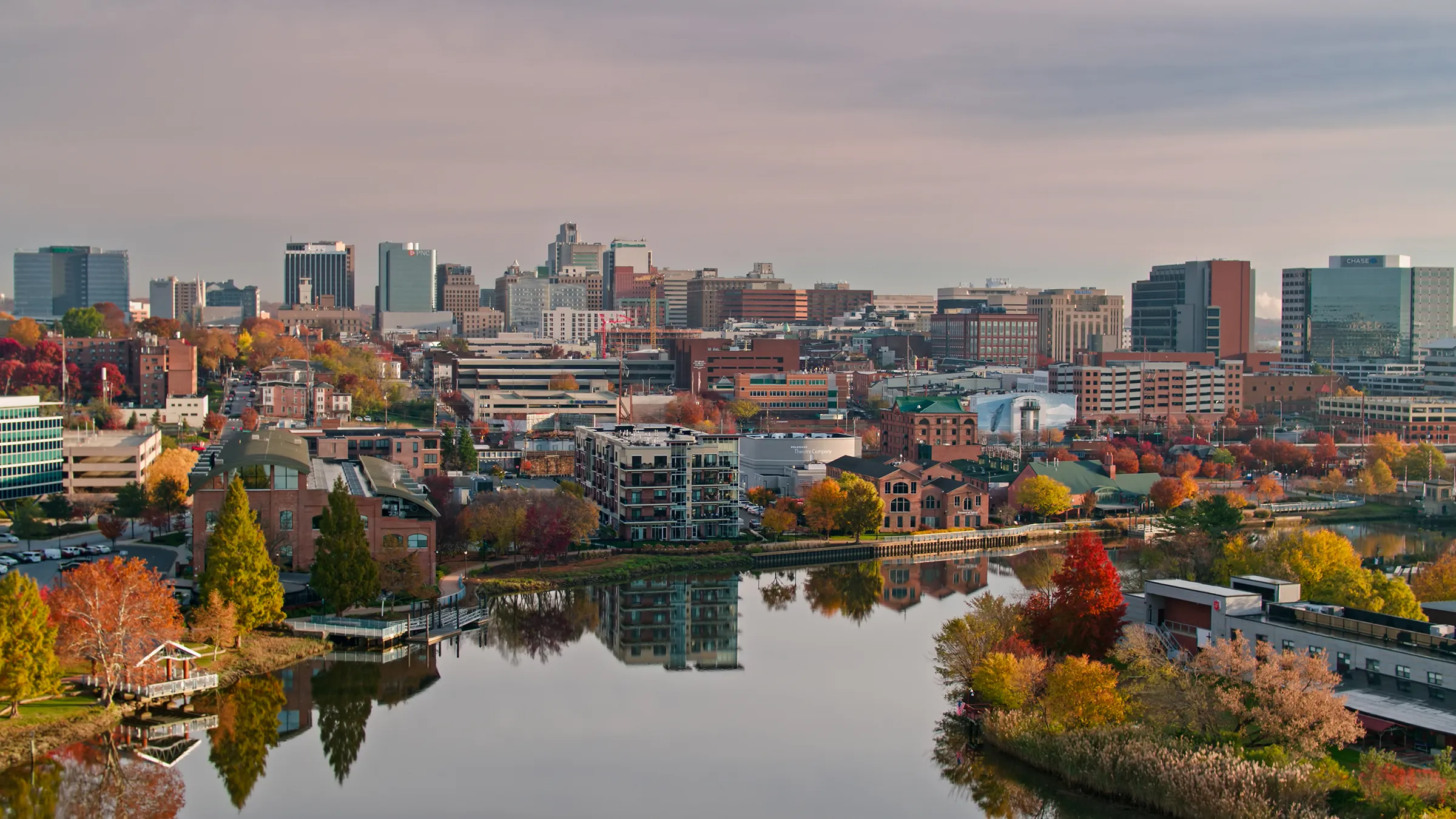 City skyline reflected in river during autumn