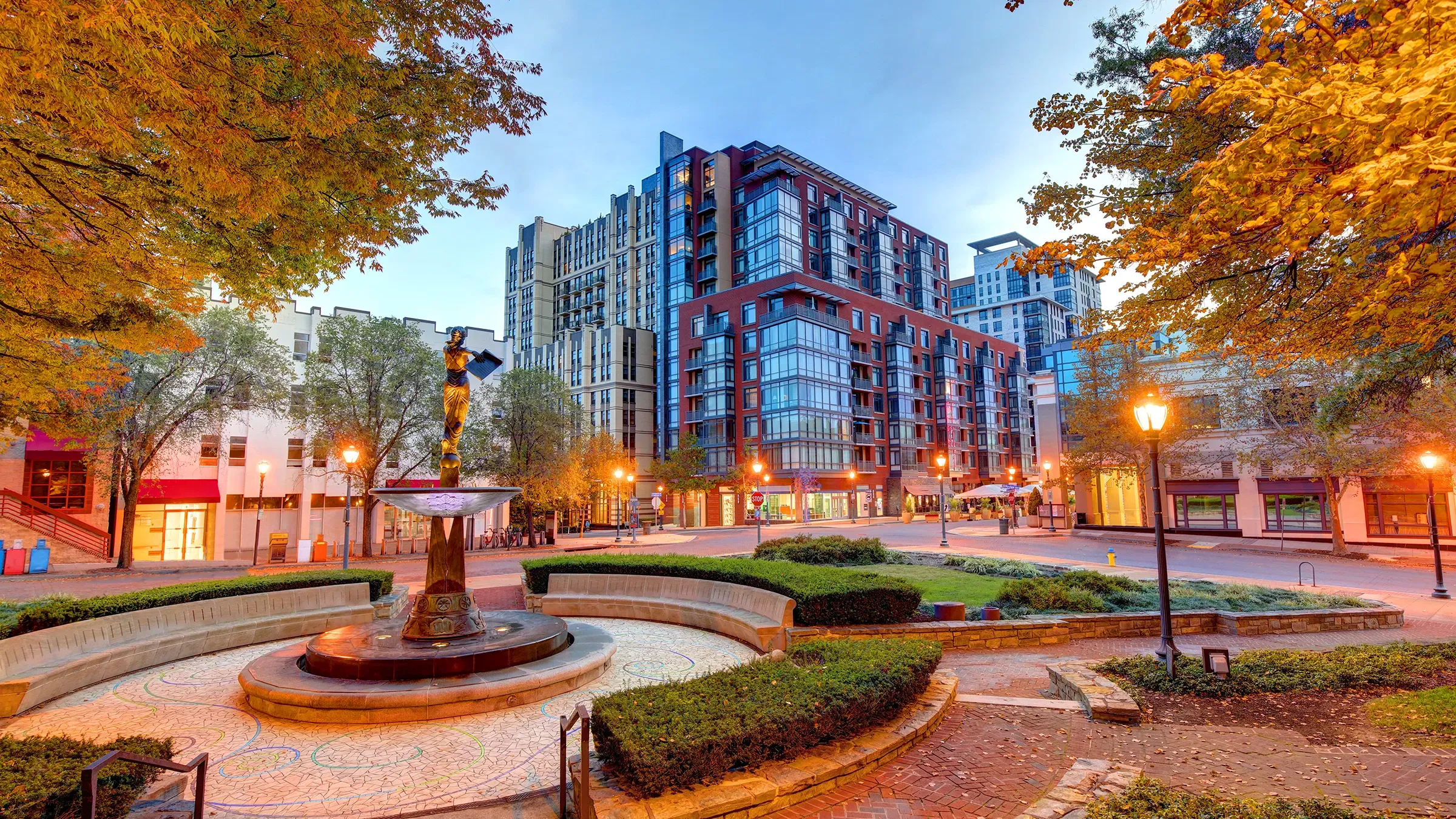Urban plaza with fountain and autumn foliage
