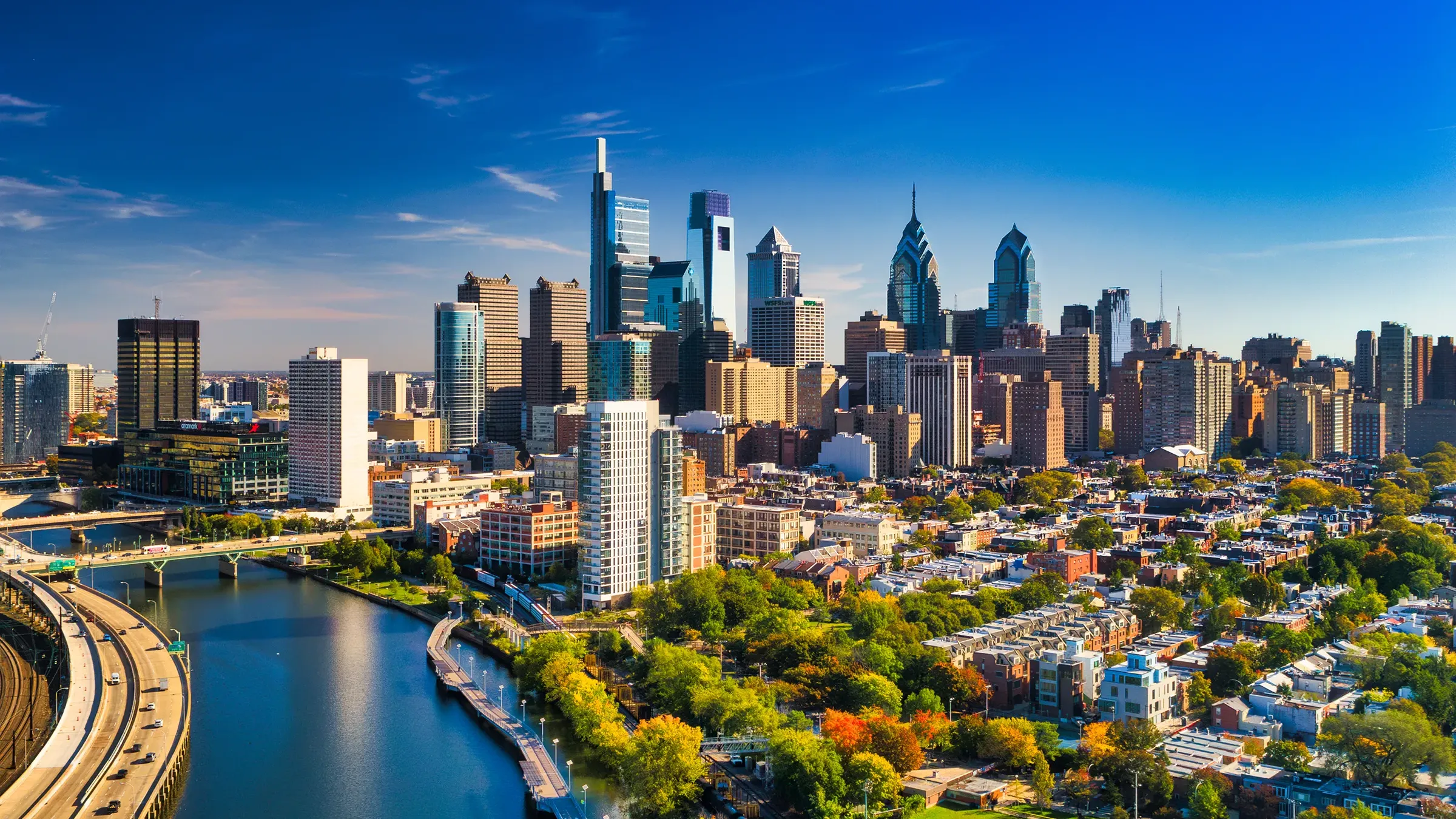 Philadelphia skyline along Schuylkill River on sunny day