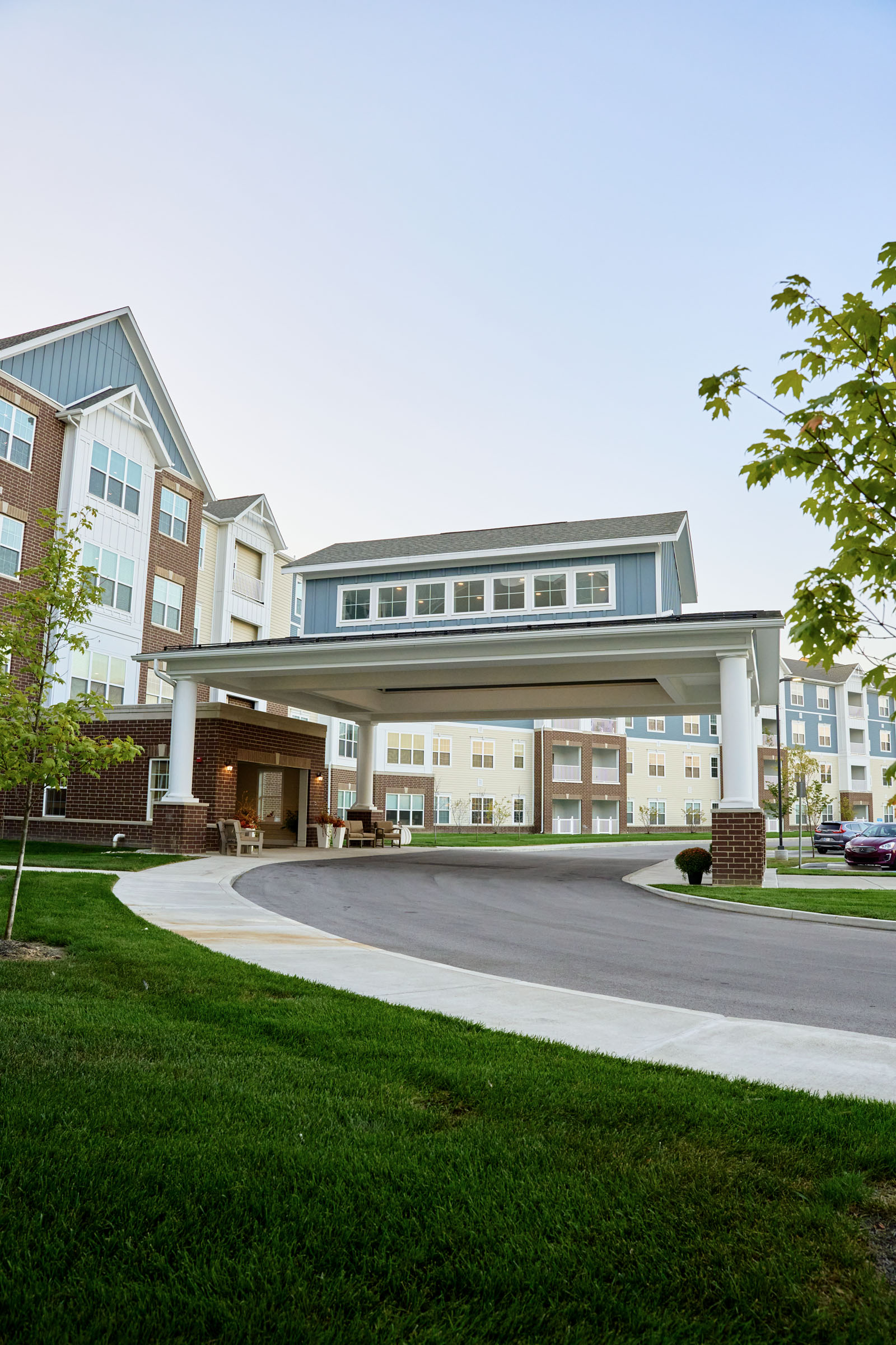 Modern apartment complex with covered entrance driveway