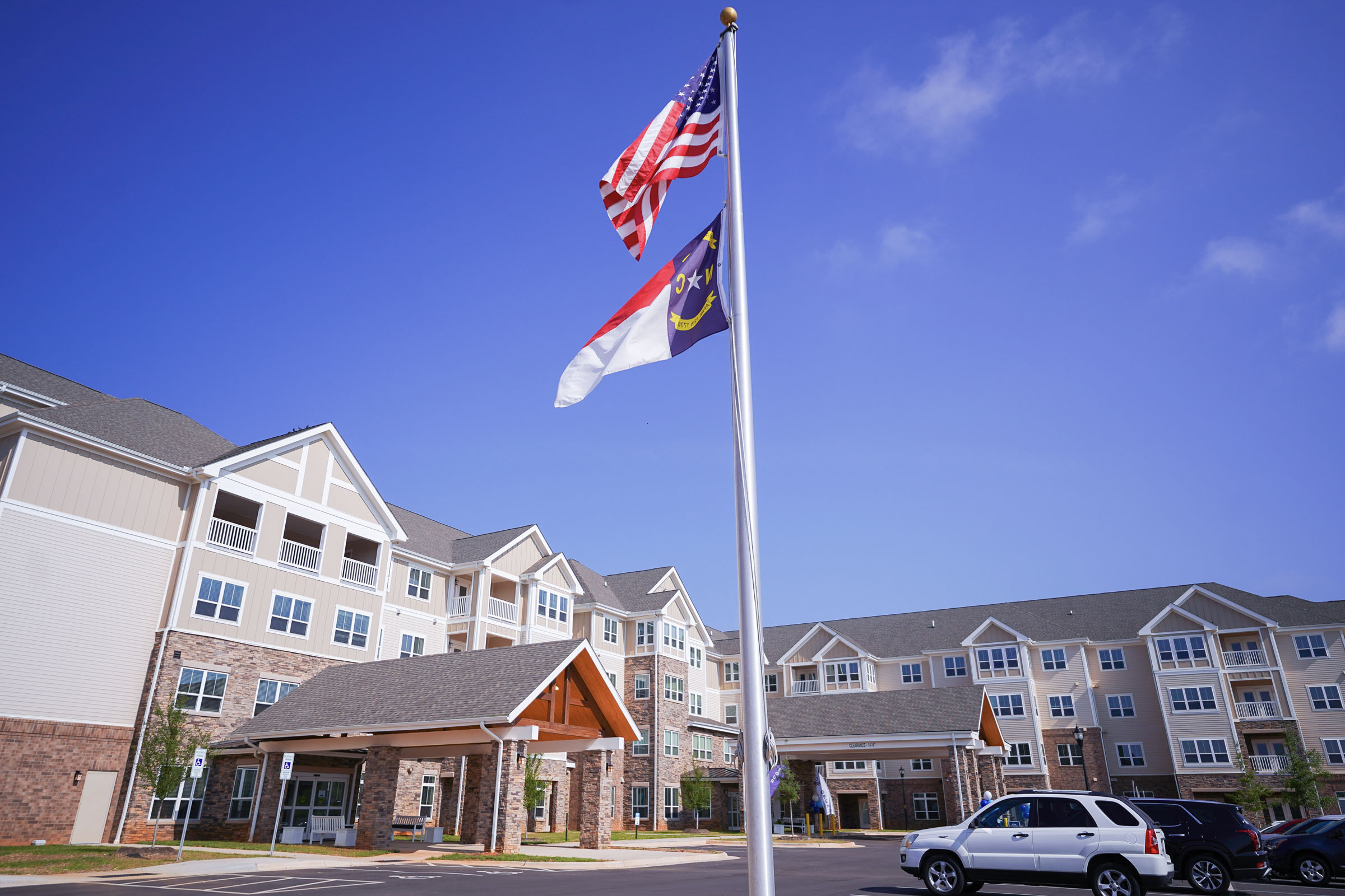 U.S. and North Carolina flags outside apartment complex