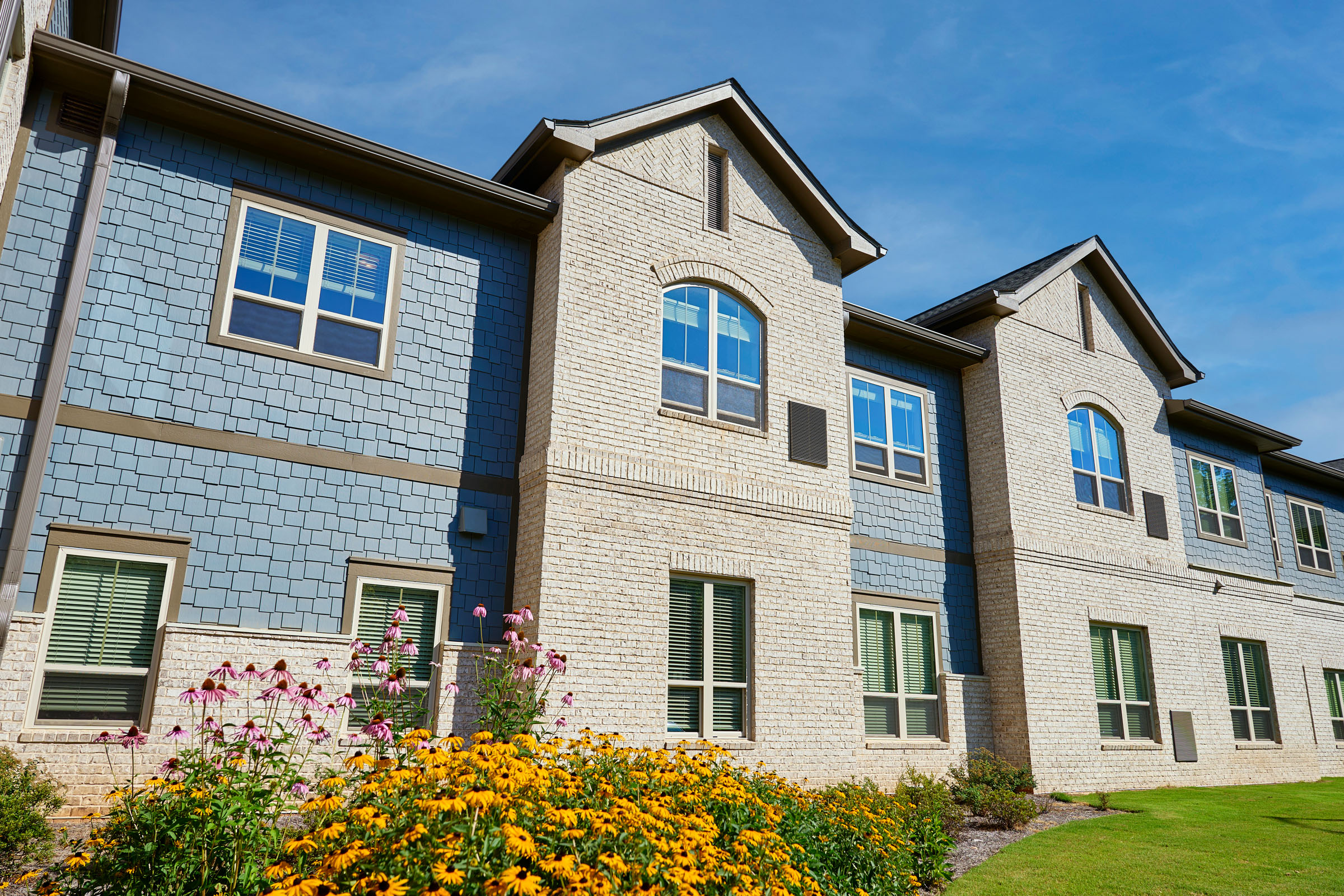 Modern apartment building with brick and blue siding